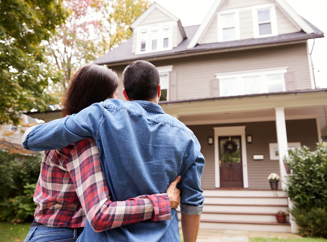 Couple in front of a house